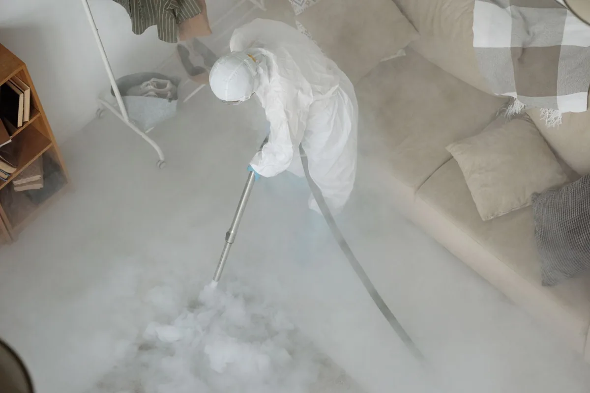 Biohazard cleanup technician in protective equipment, Gilbert Creek, WV